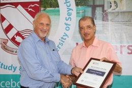 President James Michel, who is also the Chancellor of the University of Seychelles, receiving with a copy of the Certificate of Recognition of the University of Seychelles as a Registered Centre of the University of London, at a ceremony at the Anse Royal